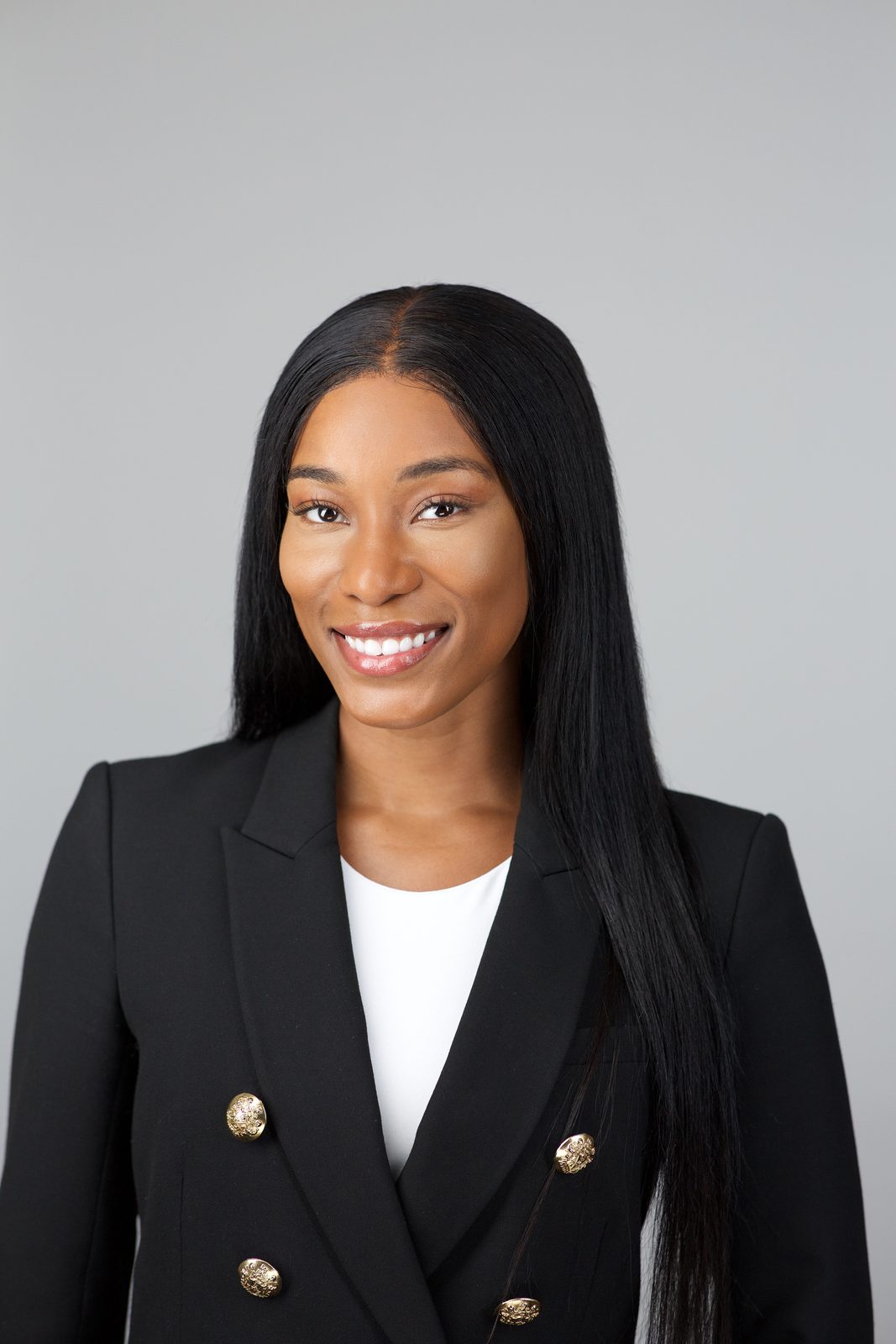 Residency application headshot — woman in a black blazer, Miami studio